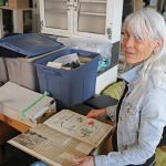 Dr. Madeline Burghardt looks through artifacts from the Manitoba Developmental Centre.