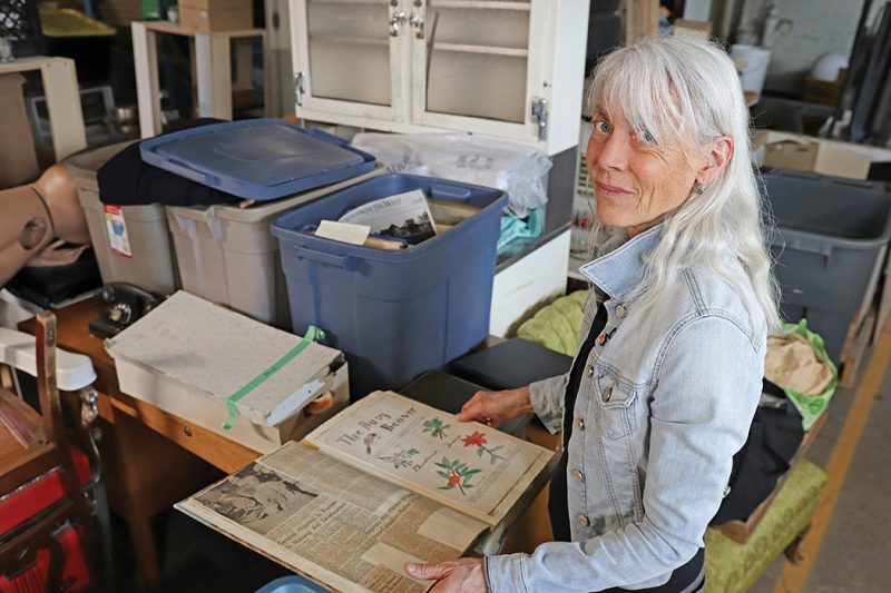 Dr. Madeline Burghardt looks through artifacts from the Manitoba Developmental Centre.
