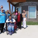 Eight people pose for a group photo outside Wiiji Bimoseyang Binesi.