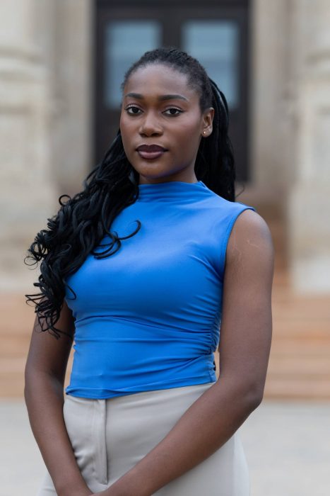 Young Black woman in a blue top.