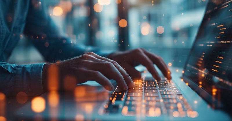 hands typing on a laptop