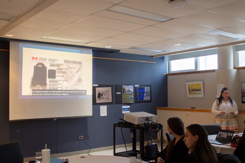 A student displays a treaty card image on screen with identifying information obscured.