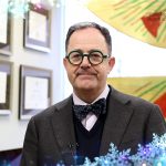 Dean Nickerson speaking in his office frames with sparkling snow