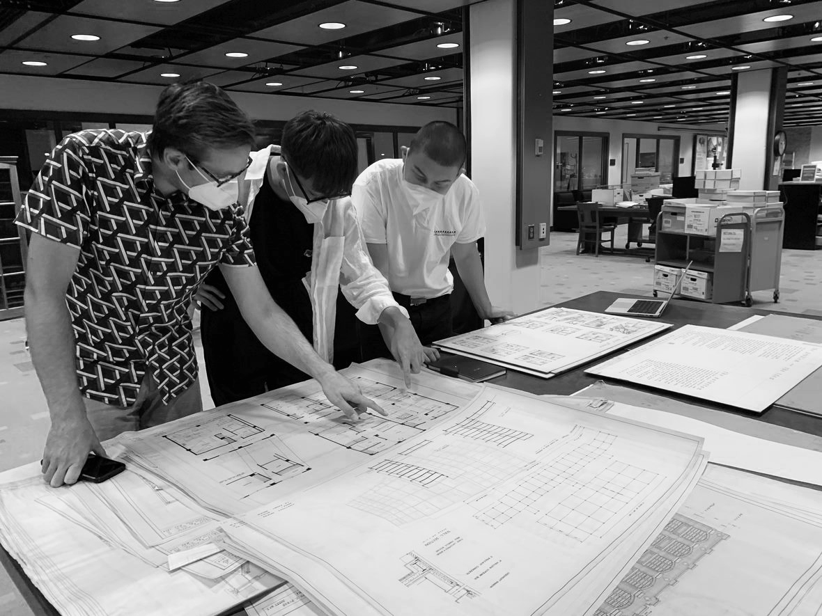 Student Researchers Daniel Guenther, Libao Wang and Tengun Bold looking at archival student work at the University of Manitoba Archives, August 4th, 2022.