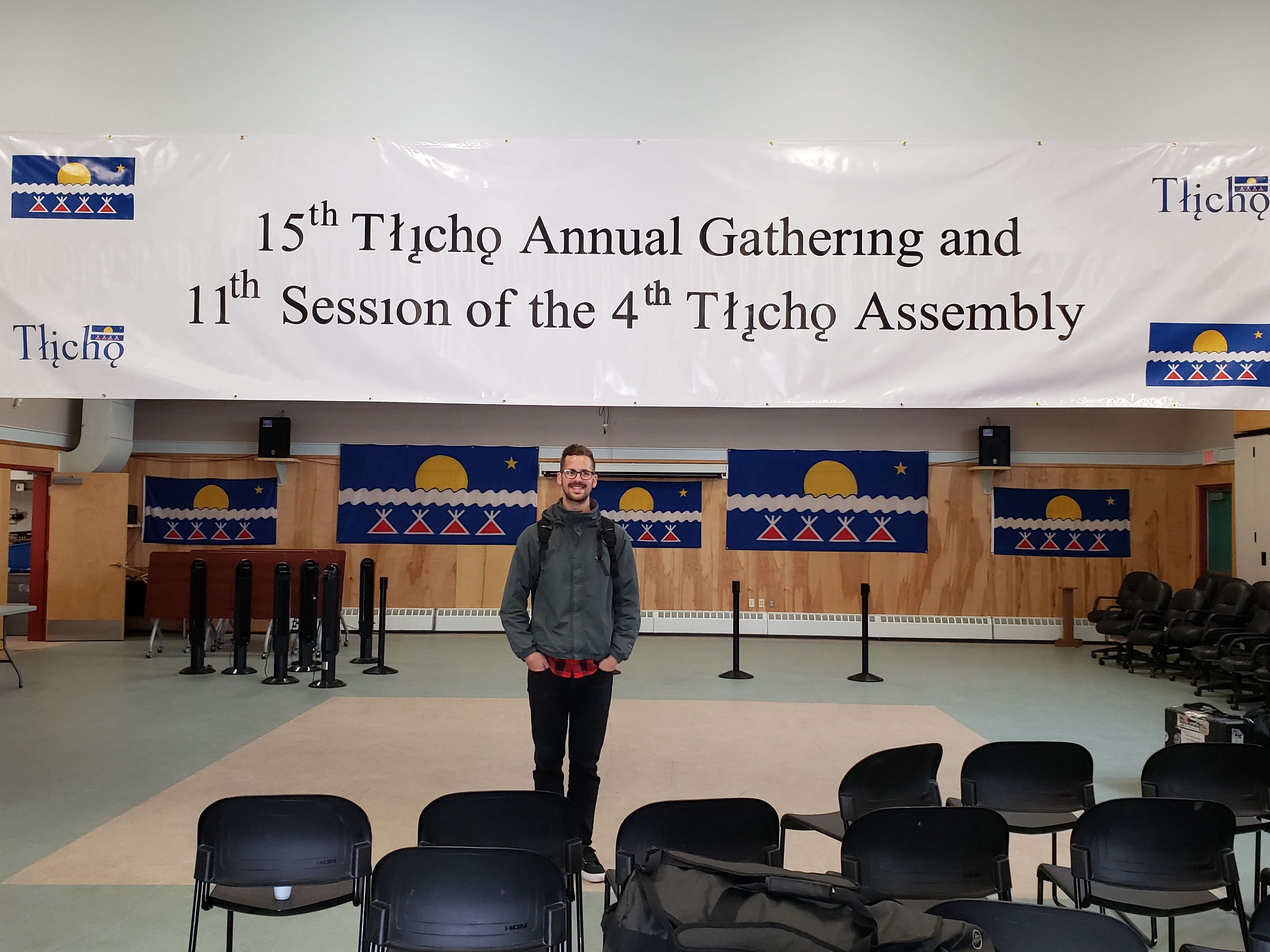 Jason Carrie with the Gathering and Assembly banner