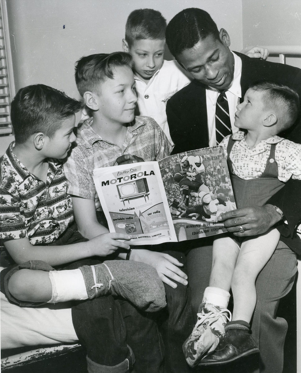 Casey reading to children at the Winnipeg Shriners Hospital in 1955.