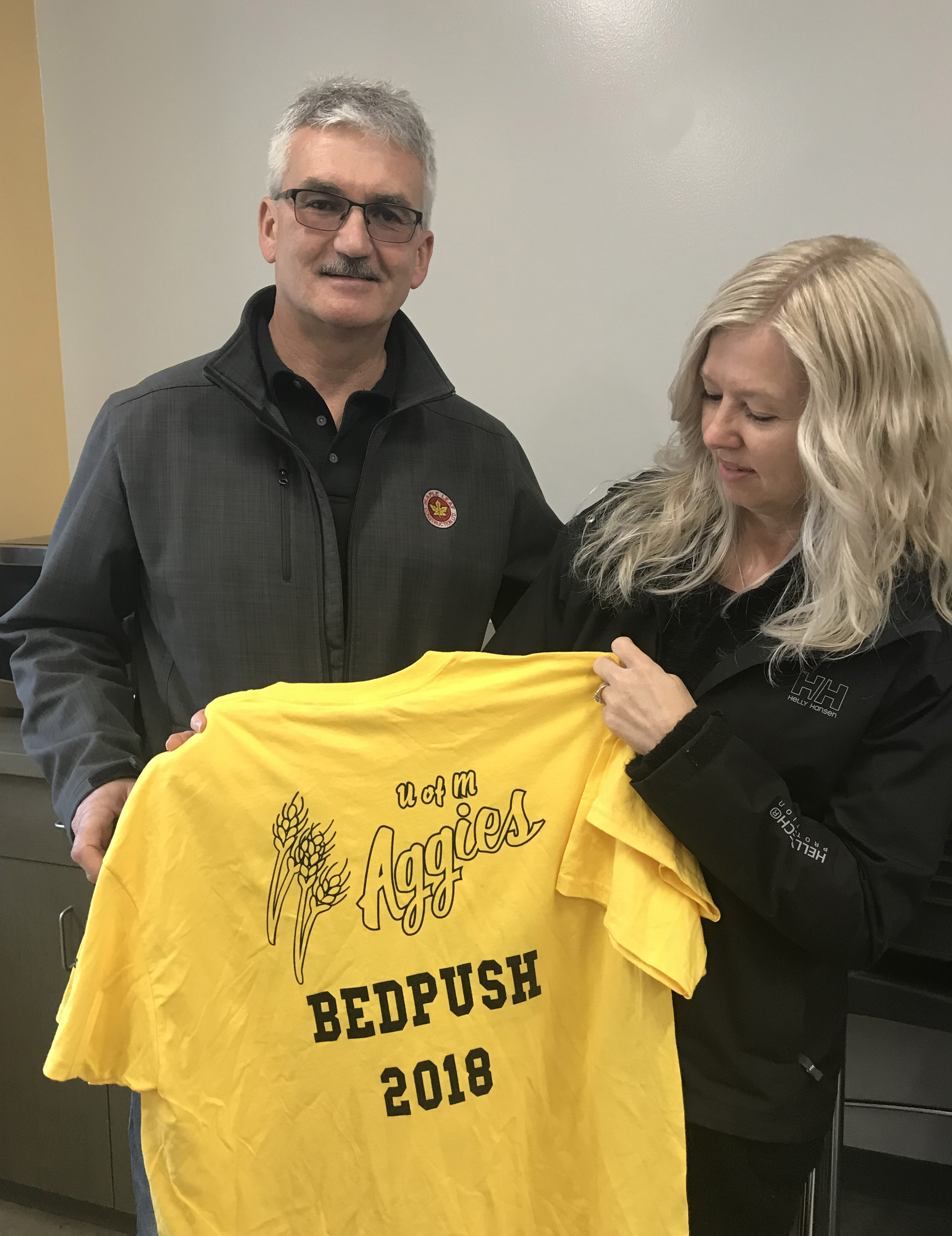 Bruce and Kim Bateman, Kyla's parents, hold the Bedpush shirt with Kyla's initials