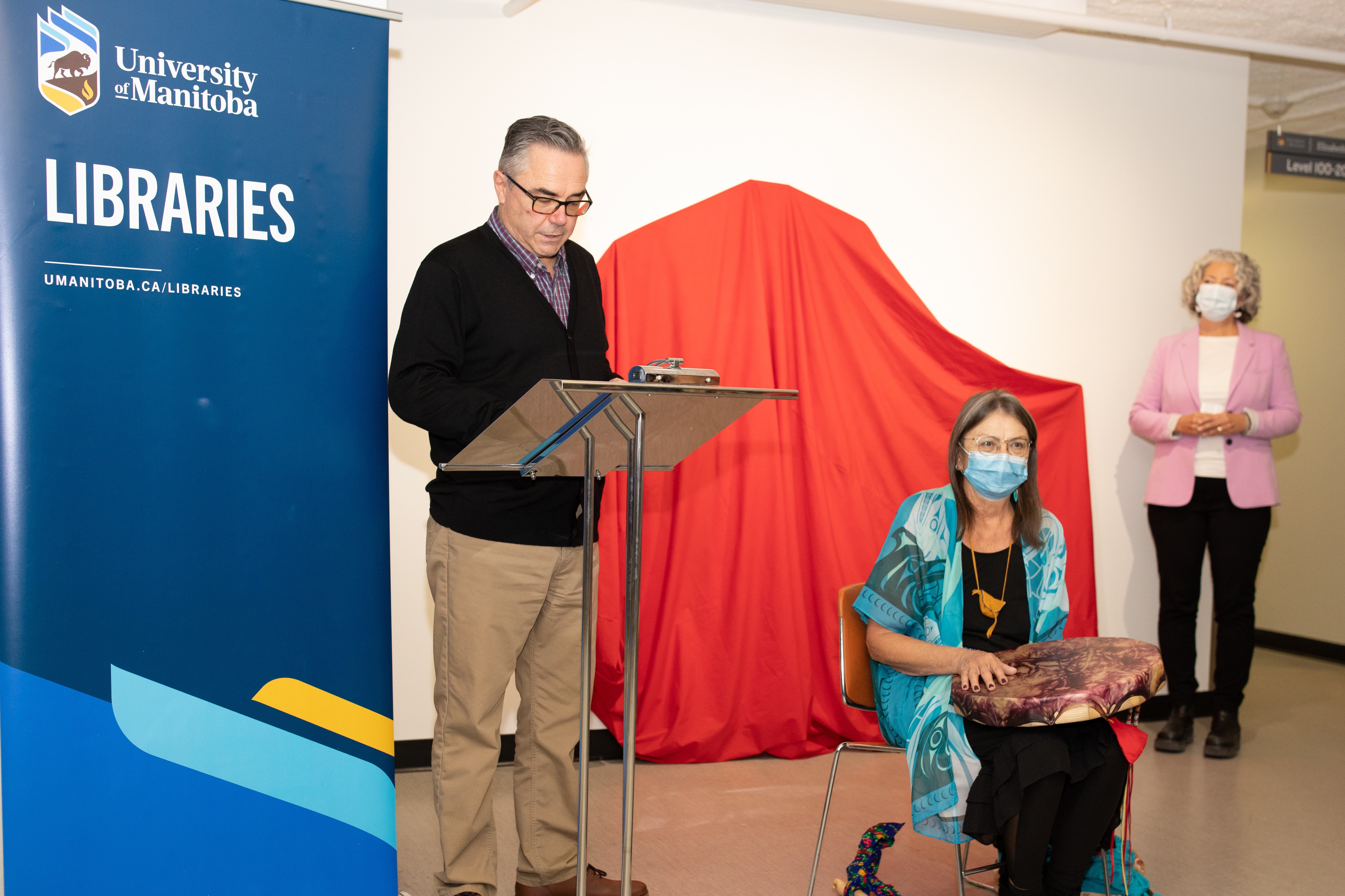Lisa O’Hara, Vice Provost (Libraries) & University Librarian (Right); Lyle Ford, Associate University Librarian for Indigenous Engagement (Left) and Val T. Vint, Métis artist (Middle) join the art opening in Elizabeth Dafoe Library.