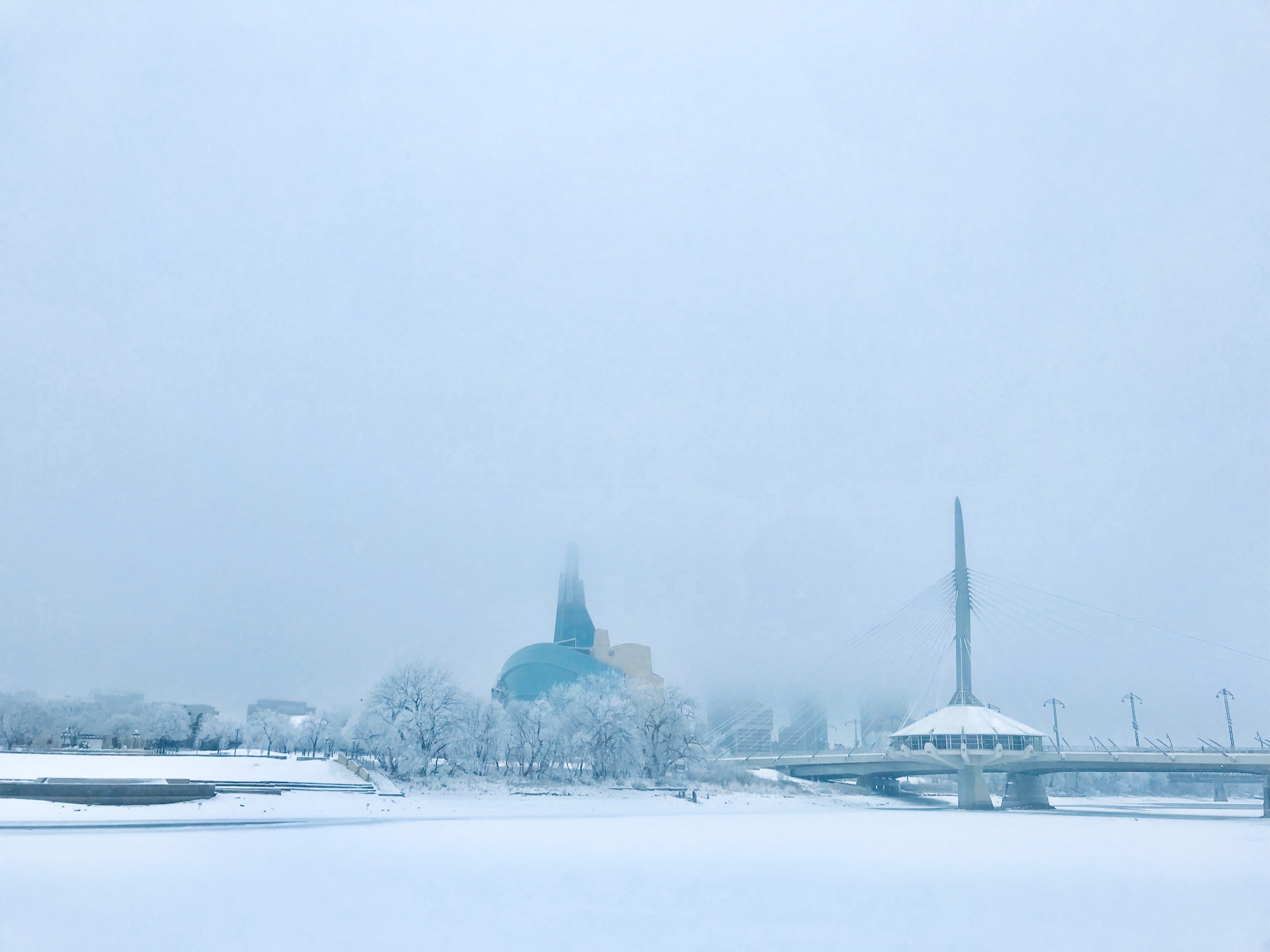 Ice fog hovers over the Canadian Museum for Human Rights and the Esplanade Bridge in Winnipeg