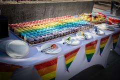 Table with rainbow Pride penants and cupcakes.