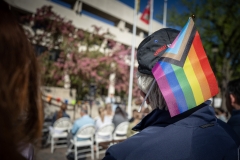 Person with pride flag in hat.